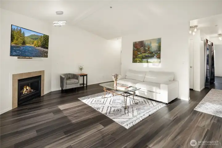 Nice Living Room Area with gas fireplace, vaulted ceilings, and lovely flooring