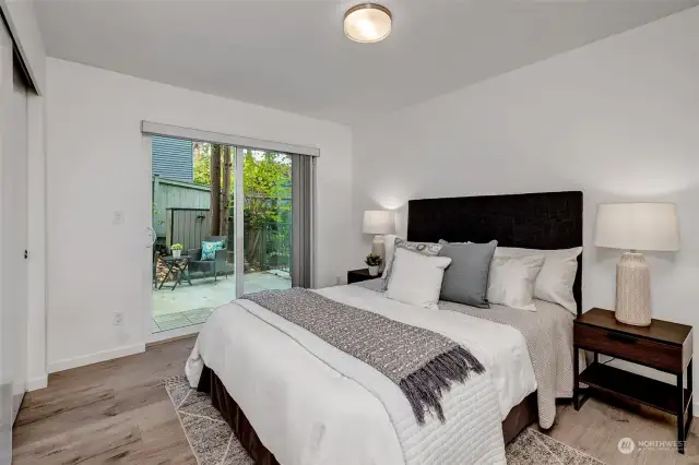 The spacious primary bedroom lives on the Northside and features access to the large private patio.