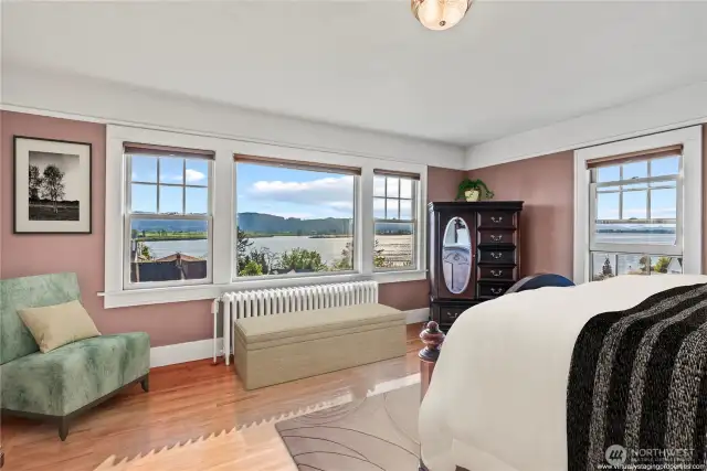 Primary bedroom with sweeping views of the Columbia River and Puget Island. Note: Partially virtual staging