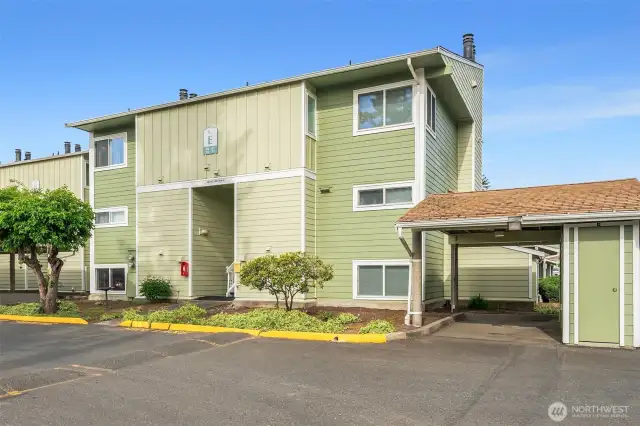 Ground-floor 1-bedroom, 1-bath unit at Seawind Condos—located on the left side of the building for easy access. Designated carport on the right side of the photo is included with the unit and features a private storage closet. Convenient, low-maintenance living in a desirable location!
