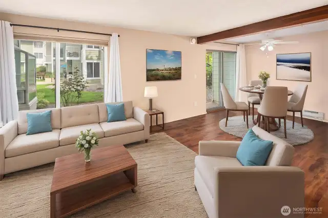 Living room flows seamlessly into the dining area, creating an open, connected space ideal for everyday living or entertaining. Sliding door off the dining area leads to a private back patio—perfect for morning coffee or outdoor dining.