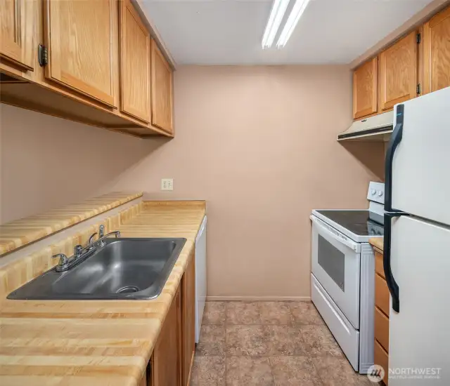Efficient kitchen layout with ample cabinet space and plenty of counter area for meal prep. Clean, functional design with easy access to the dining area—ideal for both everyday cooking and entertaining.