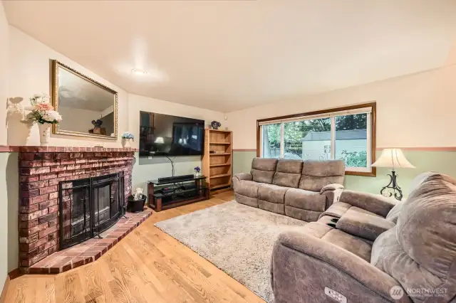 COMFORTABLE AND OPEN FAMILY ROOM W/ FIREPLACE AND VIEWS OF LUXURY BACK YARD.