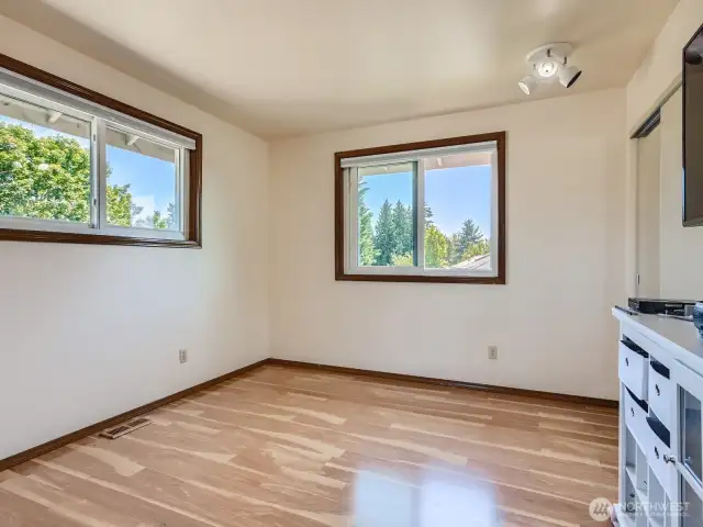 PLEASANT THIRD BEDROOM UPSTAIRS IS ENJOYABLE AND RELAXING WITH WOOD LAMINATE FLOORS.