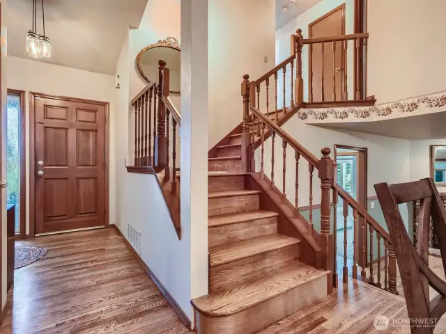 WELCOMING FOYER, WITH VAULTED CEILING AND EASY ACCESS UPSTAIRS.