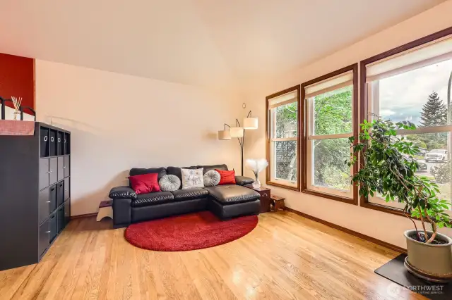 BRIGHT AND INVITING LIVING ROOM WITH PLENTY OF ROOM FOR FURNITURE, FRIENDS, AND FUN.