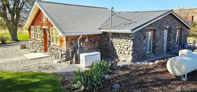 Rocks and freshly sealed cedar siding combined with metal roof = maintenance free.