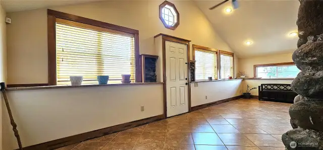 This sunfilled rooms serves as a light filled dining area and sitting area.