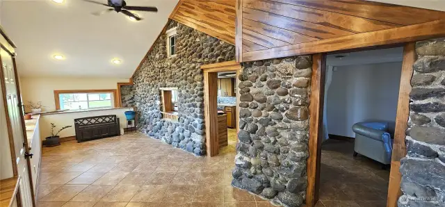 Look at that beautiful finished woodwork that compliments the rugged rock. Door on right leads to living rooms. Other door to kithcen.