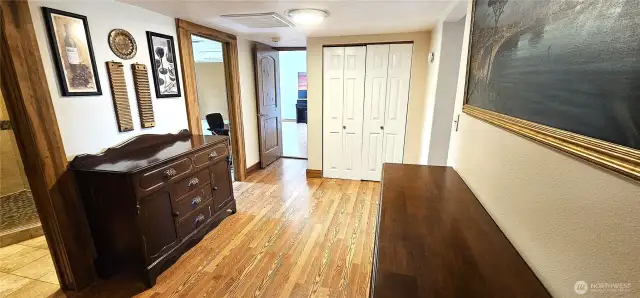 Continuing on thru the rest of the house- this hall has bath on first left, office on second left, main bedroom at end and second bedroom entrance on right. Note the gorgeous wood floors.