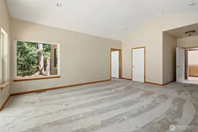 Walk in closet and entry to primary suite bath