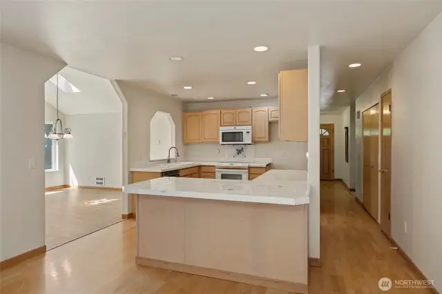 Open kitchen with so much counter space and hall pantry