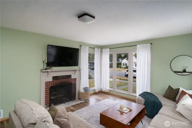 Livingroom view of large windows and the cozy wood burning fireplace
