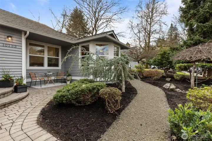 Lush, mature landscaping in front creates great curb appeal and welcomes you home.