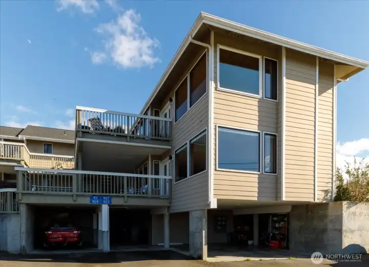 Parking is covered - second from left, with area behind it for trash & recycling bins, plus secure storage units for each unit.