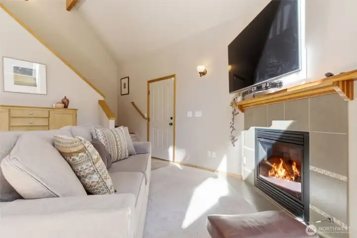 The natural light by day and firelight by evening create a balanced, inviting atmosphere. The space feels designed for lingering — for quiet mornings with coffee, lively evening conversations, and the comforting presence of a steady, glowing fire.