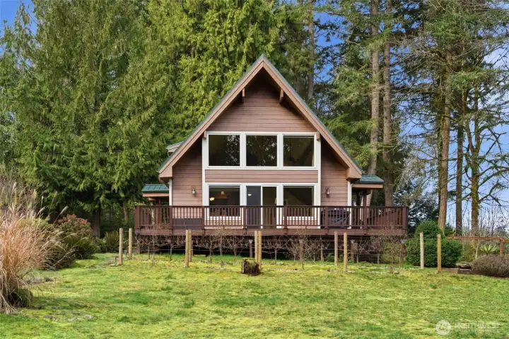 Charming A Frame style home with walls of windows for an abundance of natural light.