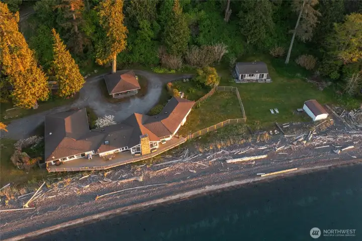 Five shoreline structures: main house, ADU, cottage, carport and boat house.