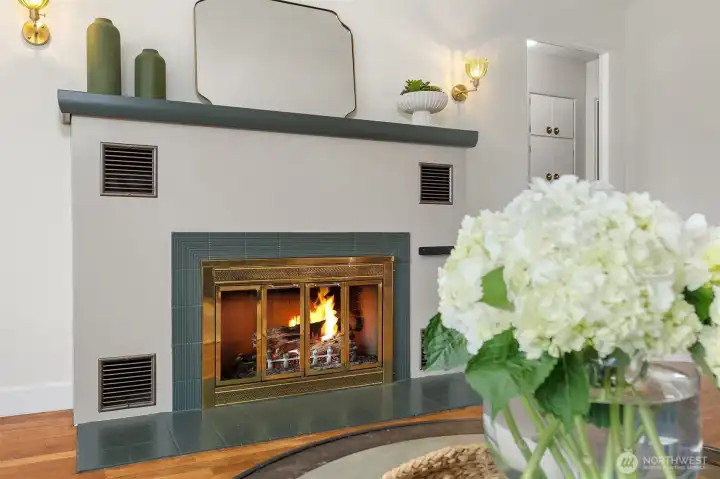 A large wood-burning fireplace is at the heart of the living room.