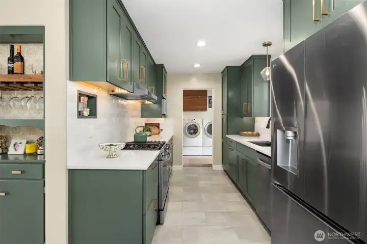 This fully equipped kitchen is right on trend with its deep green color,