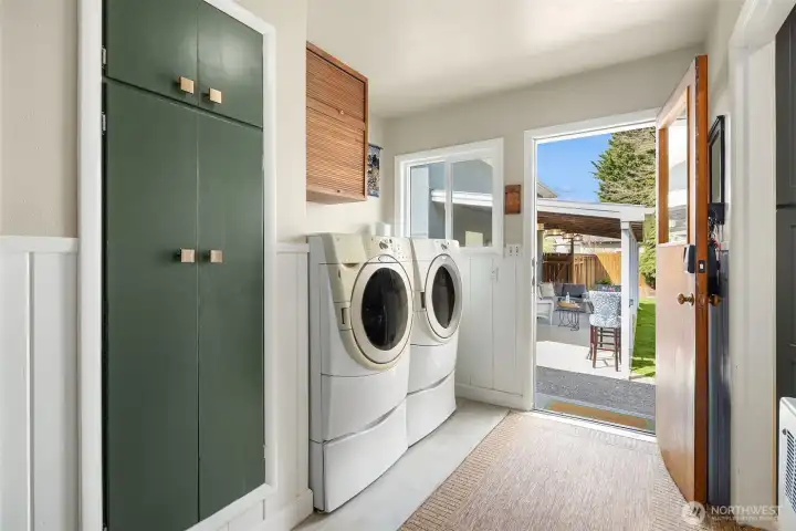 Modern mudroom and utility room combined with new luxury vinyl plank tile.