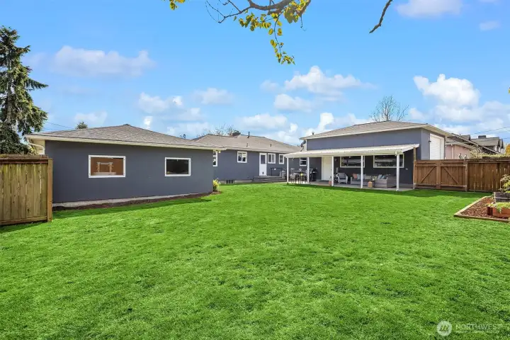 The lawn area is huge in this fully fenced back yard.
