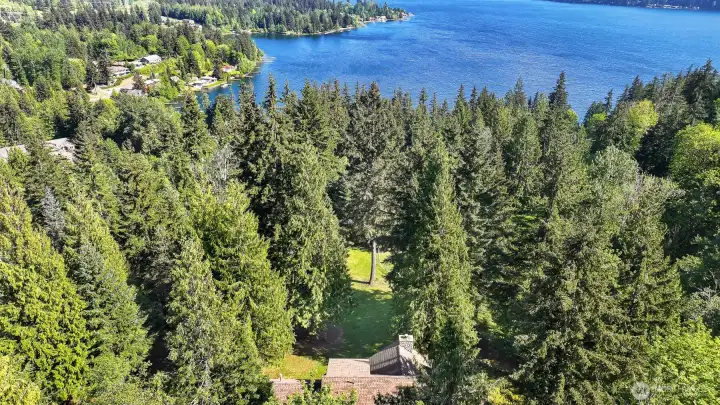 Imagine waking up every morning above the lake, surrounded by fruit trees, a seasonal creek, and three acres of pure privacy — that's not a vacation, that's your life at 3337 Agate Heights