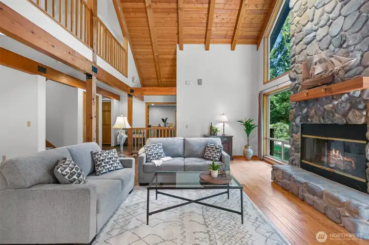 fir plank ceiling, exposed wood beams, wood fireplace.