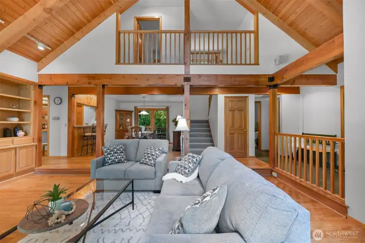 looking from the living room towards the dining room and stairs that lead to the 3 bedrooms