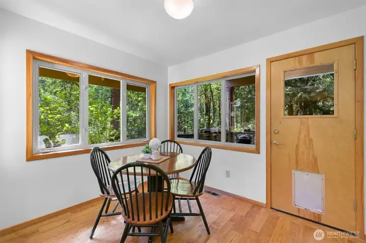 dining room adjacent to the kitchen, door leads to the back deck