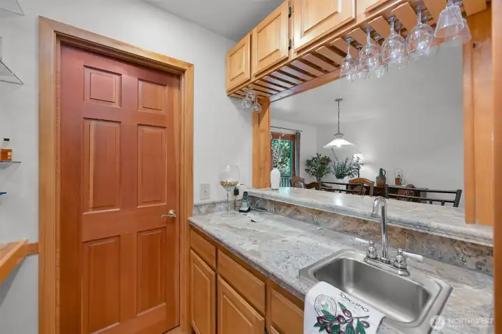 Wet bar and the door that leads to a big walk in pantry. To the left is tons of shelf space.
