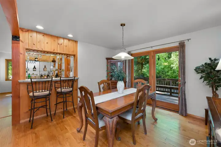knotty pine frames the eat in wet bar. 2nd larger dining room has doors to the back deck