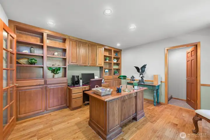 French doors open to a spacious office with built in shelves/cabinets. Door leads to the upstairs bonus room