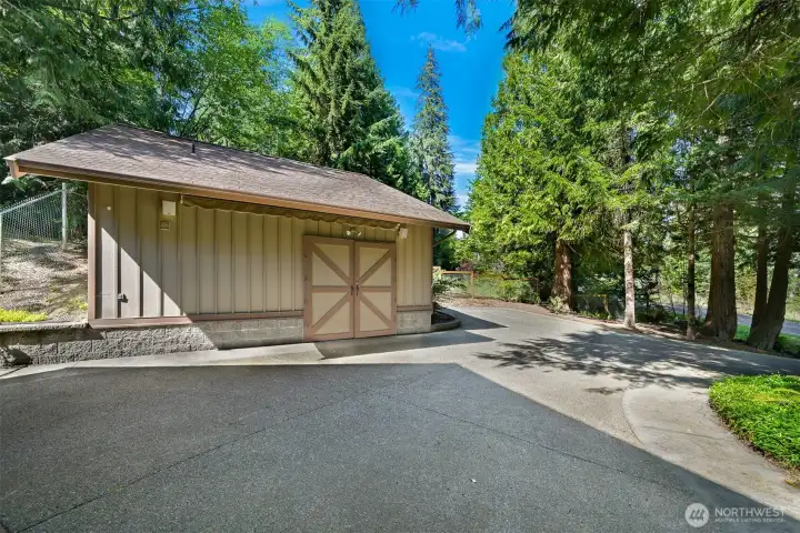 Well built shop with electric awning, half bath, countertops with sink and 2nd floor loft. Also lots of parking!