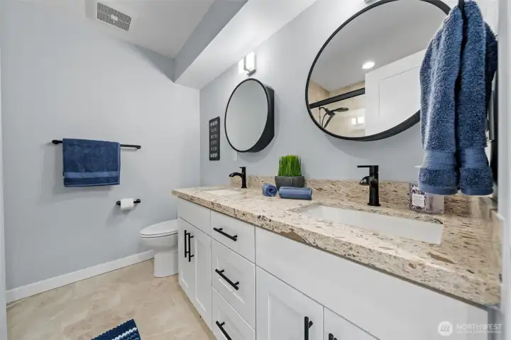 Double sink bathroom with mirrors that open the right way