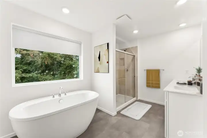 Primary bathroom with a spa-inspired soaking tub, dual vanities, tile shower, separate toilet room, and walk-in closet.  Picture for representational purposes only, colors and features may vary.