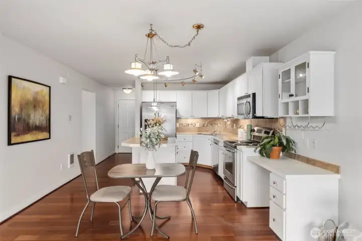 Open concept kitchen with eating space at the island and room for another table too Open concept kitchen with eating space at the island and room for another table too