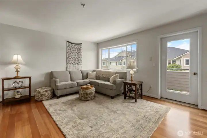 Large, bright living area with balcony access Large, bright living area with balcony access