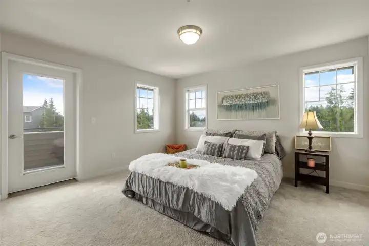 Large primary bedroom with newer carpet, private balcony access and attached full bathroom Large primary bedroom with newer carpet, private balcony access and attached full bathroom