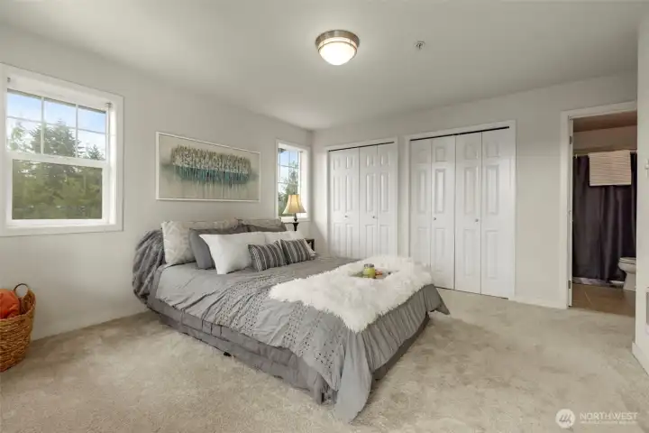 Large primary bedroom with newer carpet, private balcony access and attached full bathroom Large primary bedroom with newer carpet, private balcony access and attached full bathroom