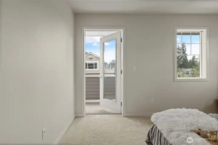 Large primary bedroom with newer carpet, private balcony access and attached full bathroom Large primary bedroom with newer carpet, private balcony access and attached full bathroom