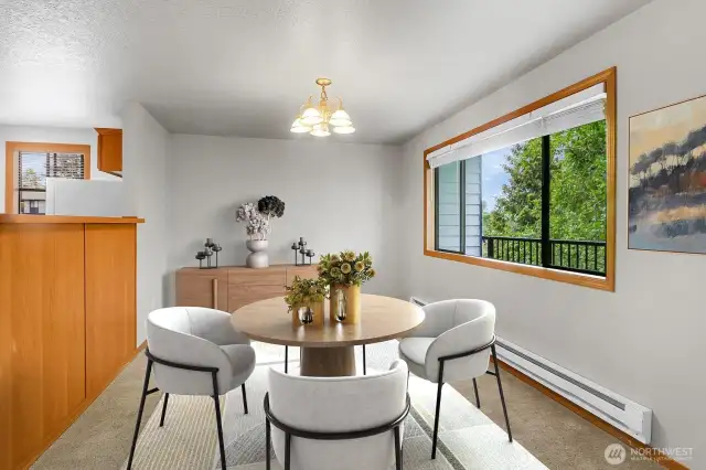 Large dining area that flows from Living room. Enjoy natural light. This room is large enough for a table, side board or larger dining table. Virtually staged