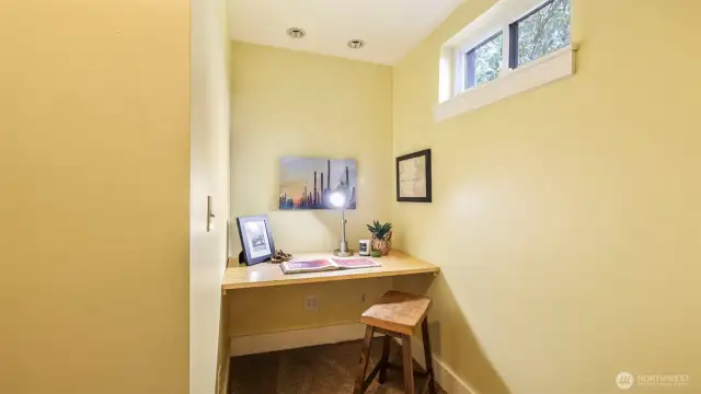 Landing at the bottom of the basement stairs with built in nook