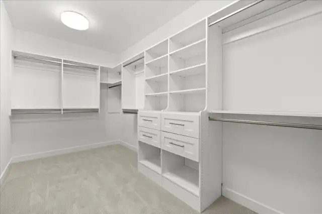Spacious primary walk-in with custom shelving