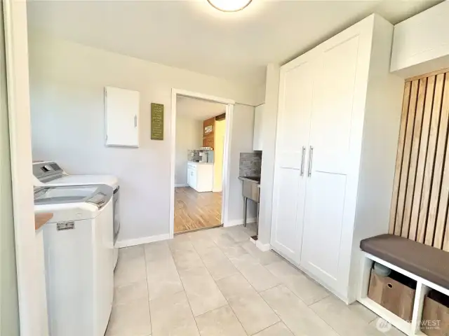 Main home back entry utility room with deep sink.