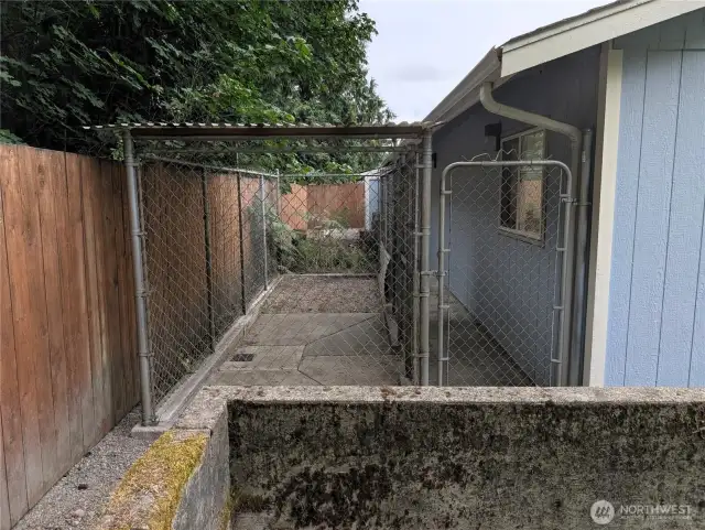 8' x 12' kennel. Fully fenced property backs up to a green belt on 2 sides for privacy, and fully fenced backyard for pets. Say Yes to this address. #7120 242nd St E, Graham, WA 98338.
