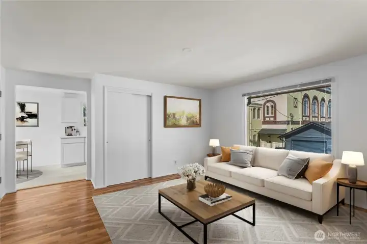 Unit E Living room looking into kitchen, virtually staged