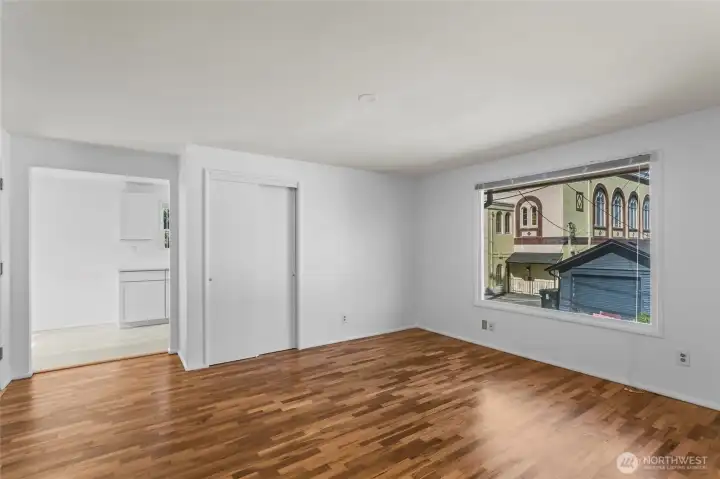 Unit E Living room with original newly polished hardwood floors