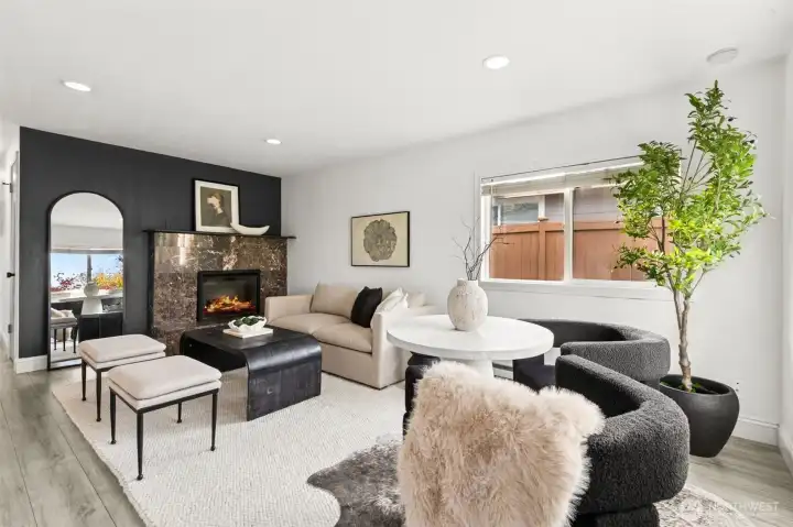 Stylish, light-filled living room at 4612 N 21st St, Tacoma, WA — featuring modern updates, luxury fireplace with marble surround, large window for natural light, designer furniture layout, and spacious open-concept feel. Ideal North Tacoma home for buyers seeking a move-in-ready space with contemporary finishes near the Proctor District.