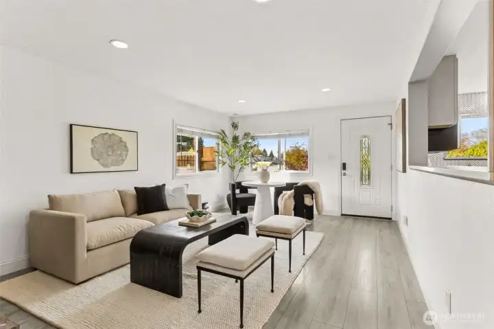 Bright and modern main living area at 4612 N 21st St, Tacoma, WA — featuring wide-plank flooring, large dual-pane windows with natural light, open layout, stylish neutral décor, and a cozy dining nook with views of the neighborhood. This beautifully updated North Tacoma home offers an inviting entry and seamless flow perfect for comfortable living and entertaining.